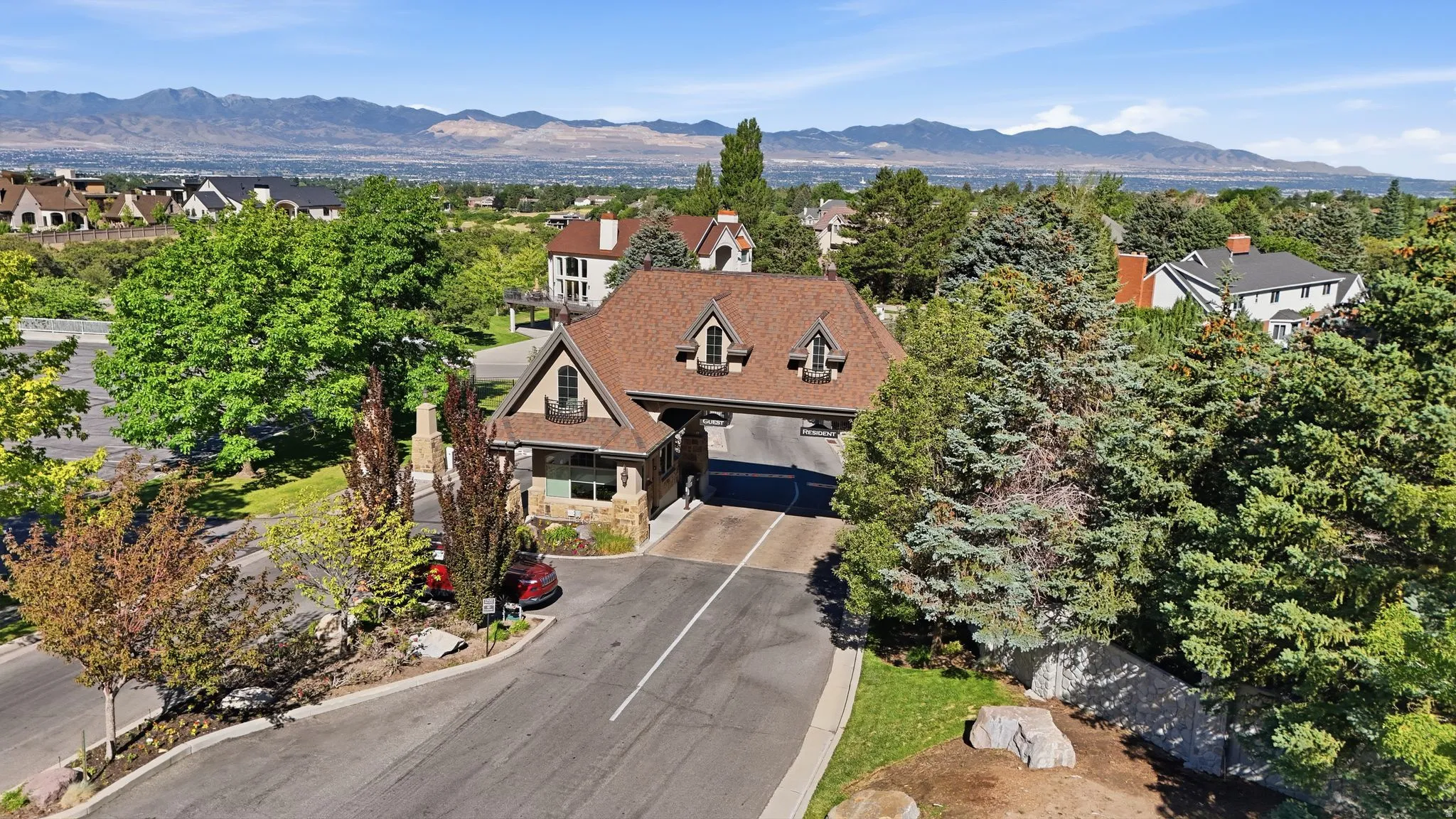 Gabled roofline residence featuring stone accents and decorative dormers