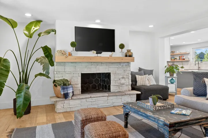 Living area with wood-finish flooring and recessed lighting