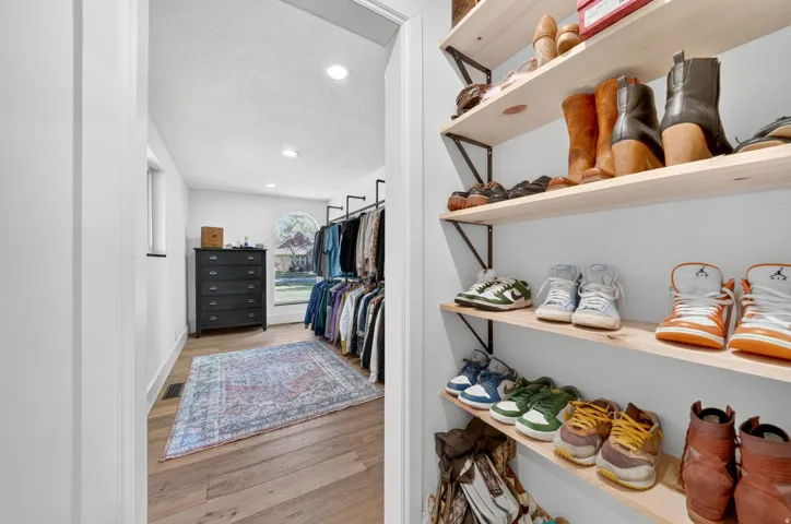 Custom closet system featuring built-in shelving and clothing racks