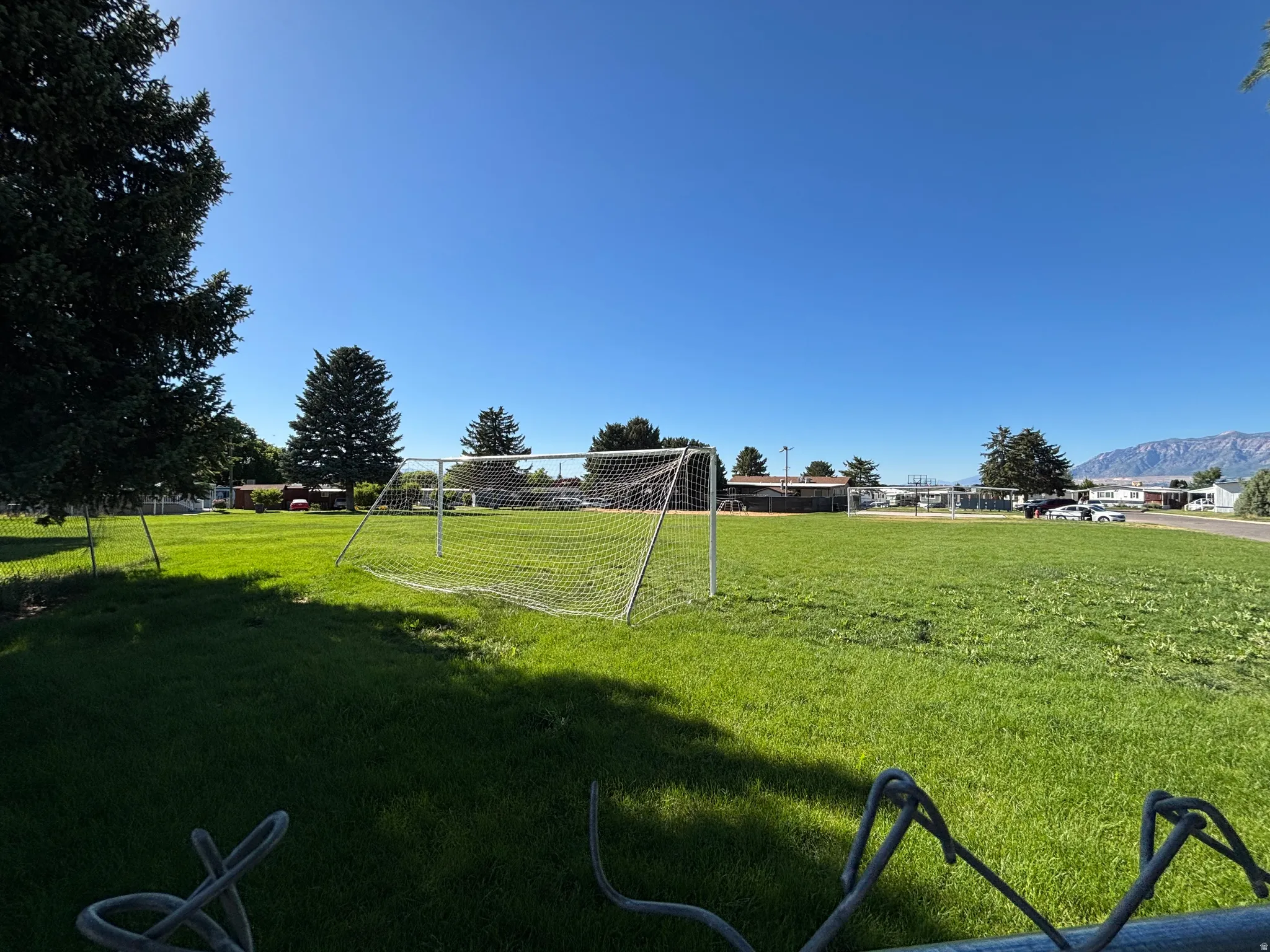 Expansive green field featuring a prominent soccer goal