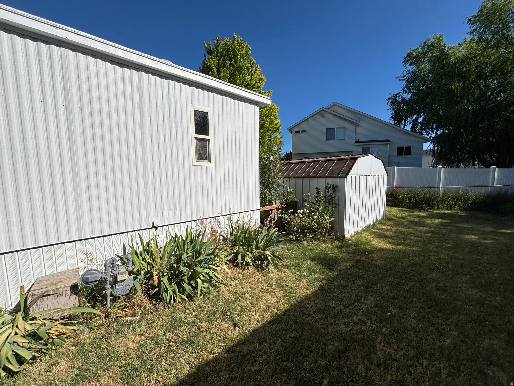 White corrugated exterior siding with a single window
