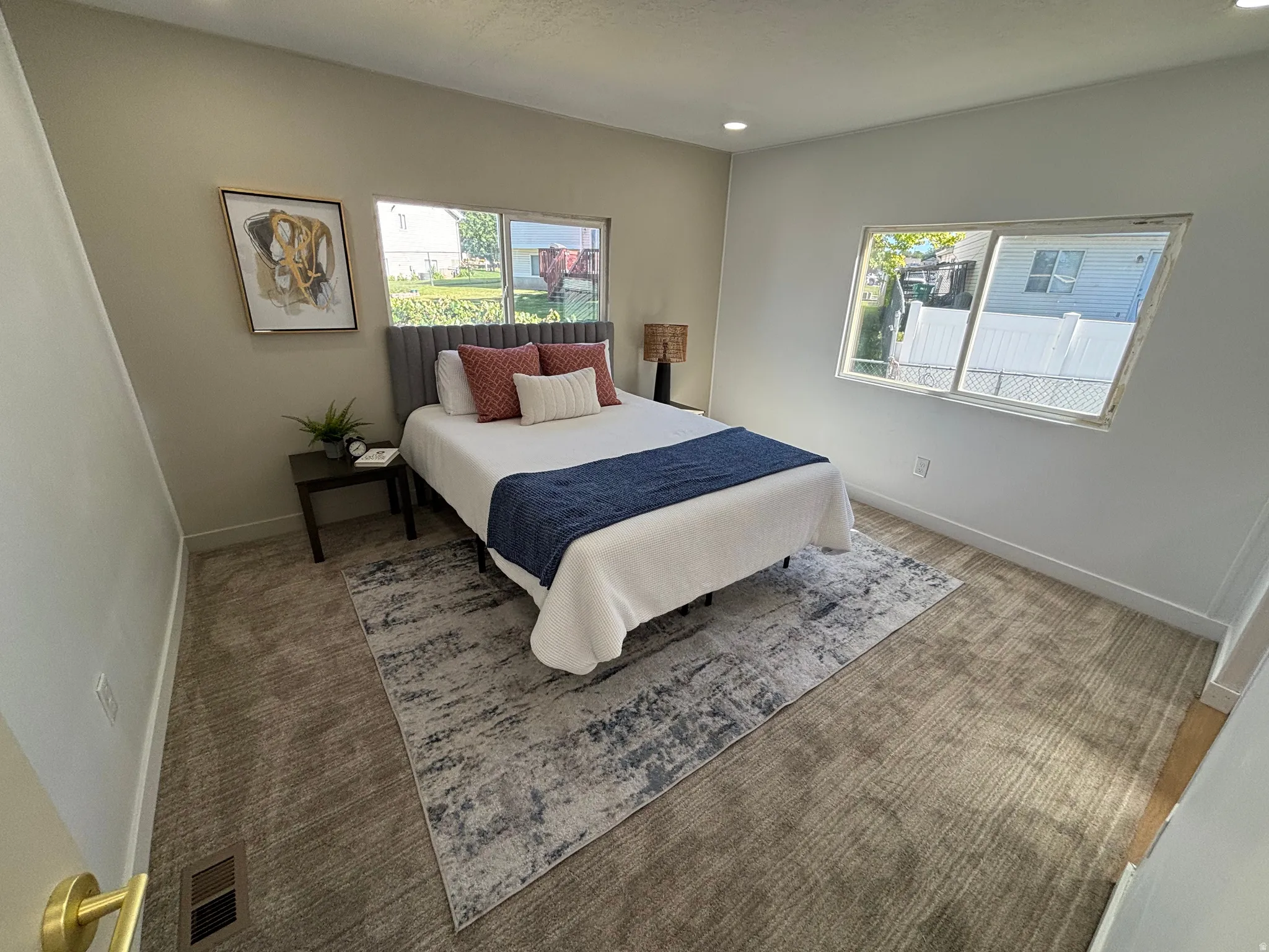Room featuring neutral wall tones, recessed lighting, expansive windows, and textured carpeting