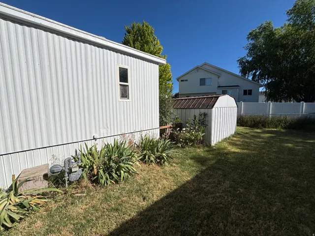 White corrugated exterior siding with a single window