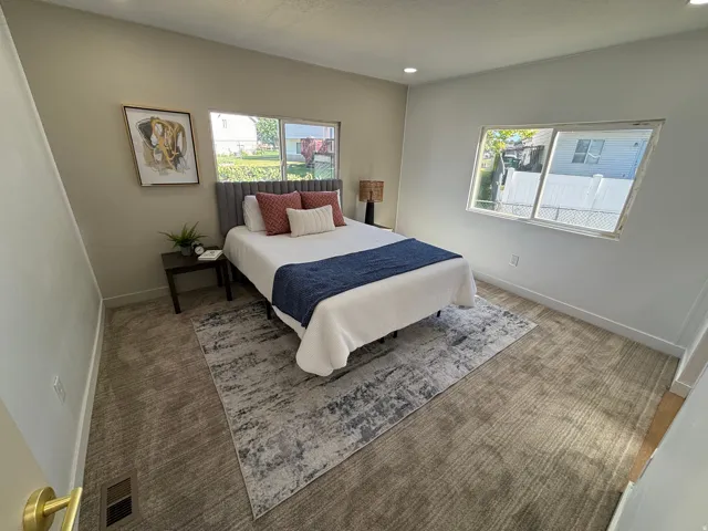 Room featuring neutral wall tones, recessed lighting, expansive windows, and textured carpeting