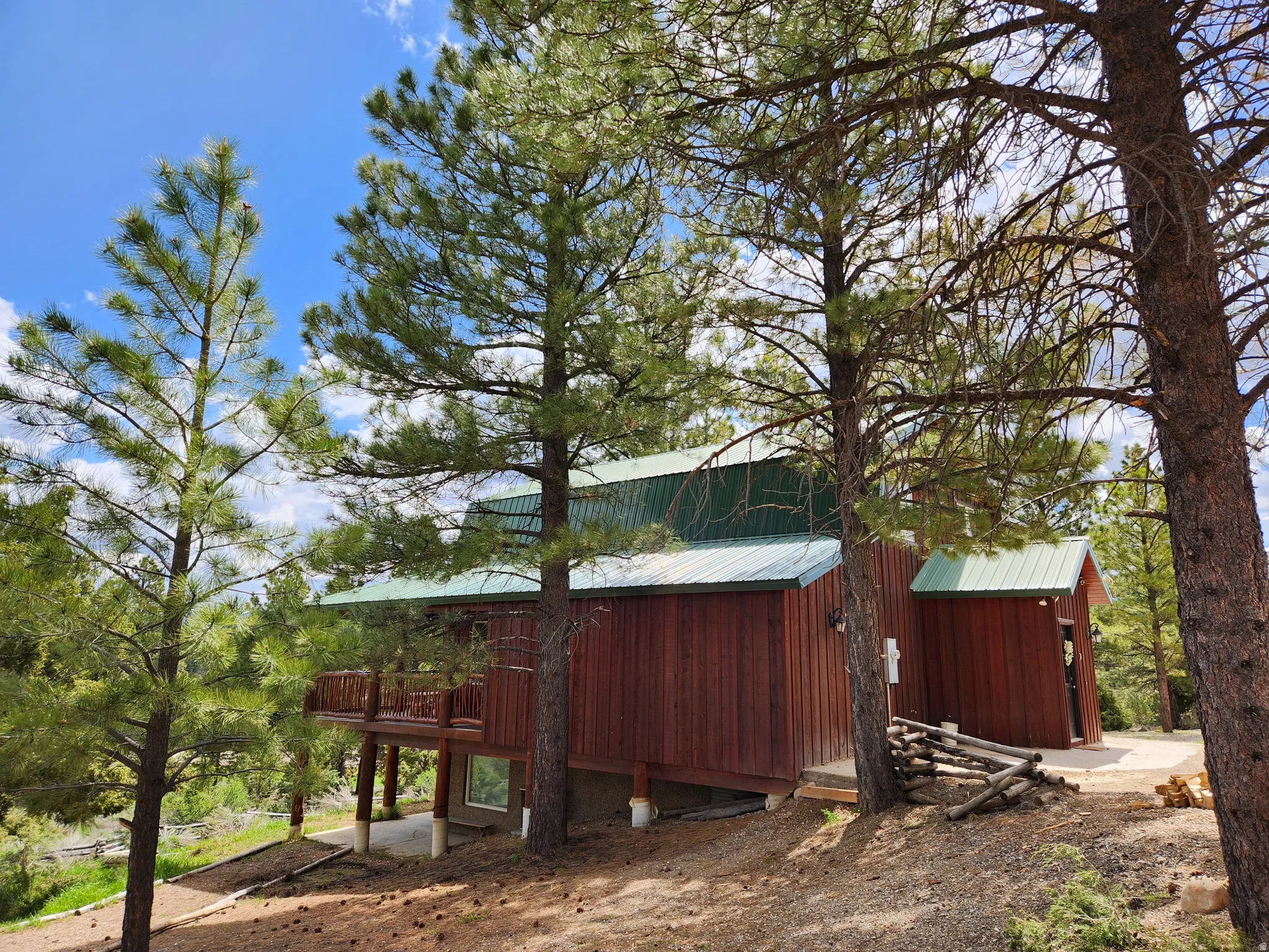 Wood-sided exterior featuring a green metal roof