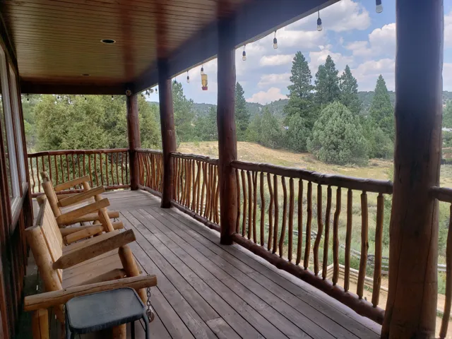 Expansive wood deck with natural log railings and supporting posts