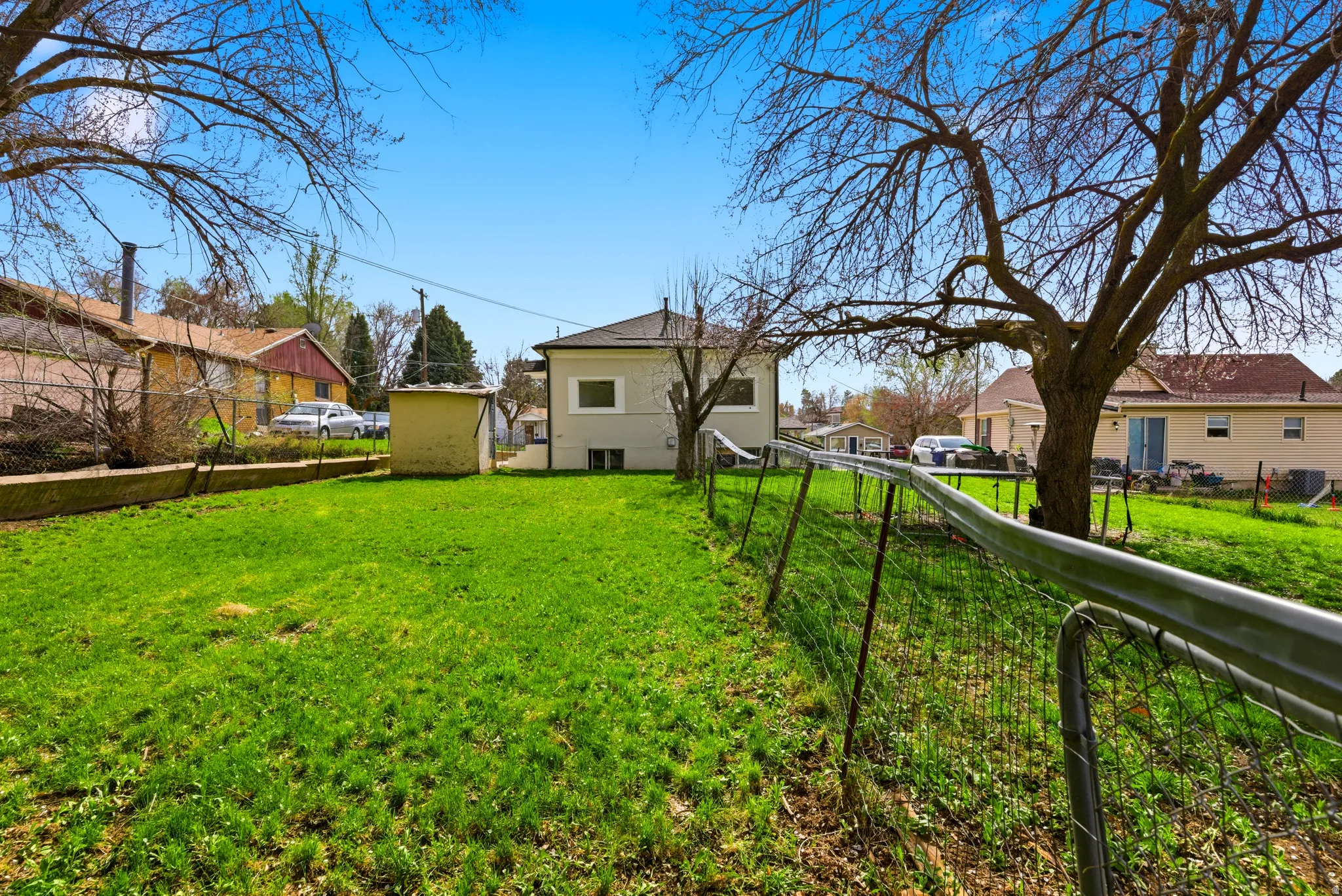 Fenced yard featuring a residential view