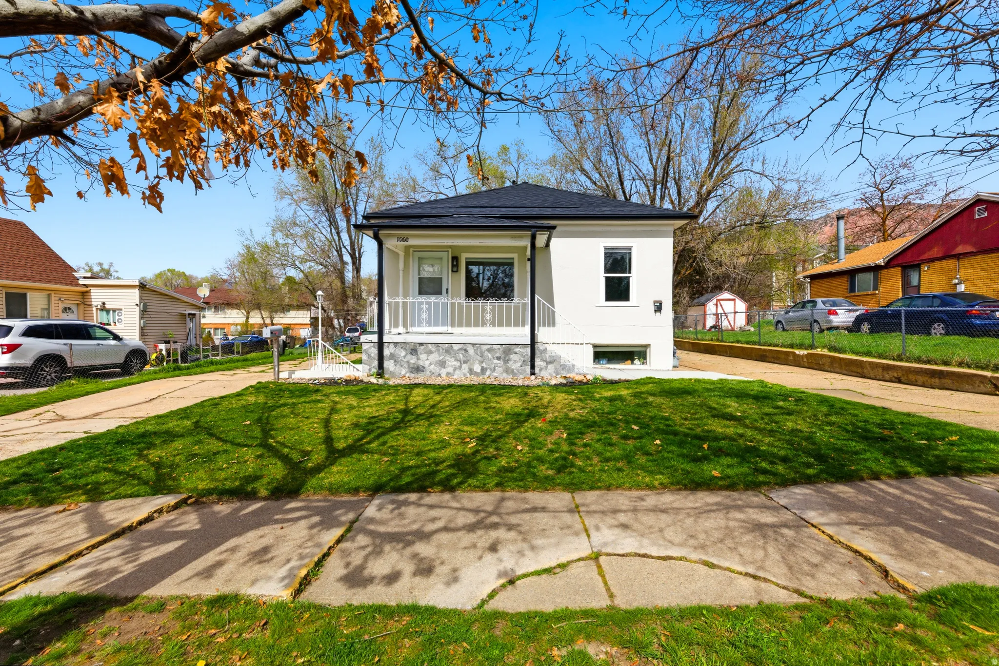 View of front facade featuring covered porch and stucco siding