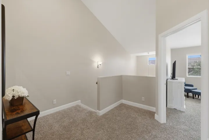 Carpeted upstairs landing with neutral wall tones and white baseboards