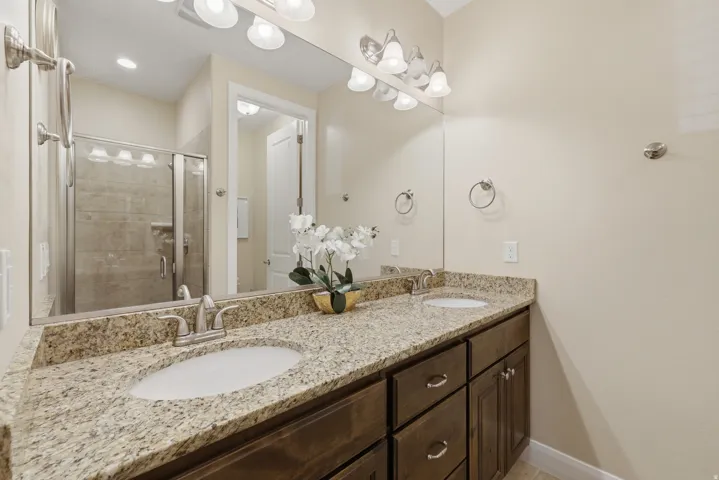 Dual vanity with light-toned granite countertop and undermount sinks