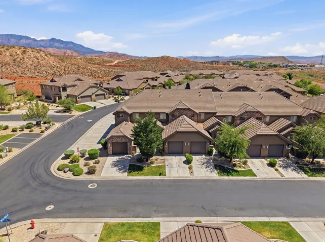 Brown-toned residences featuring attached garages and tiled roofs