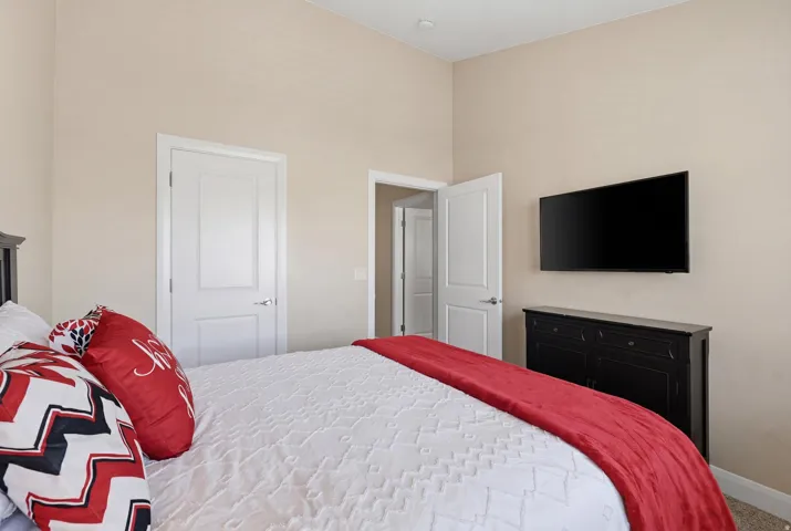 Spacious bedroom with vaulted ceilings and neutral wall tones