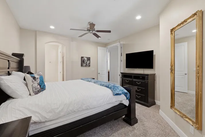 Carpeted bedroom with neutral wall tones and recessed lighting
