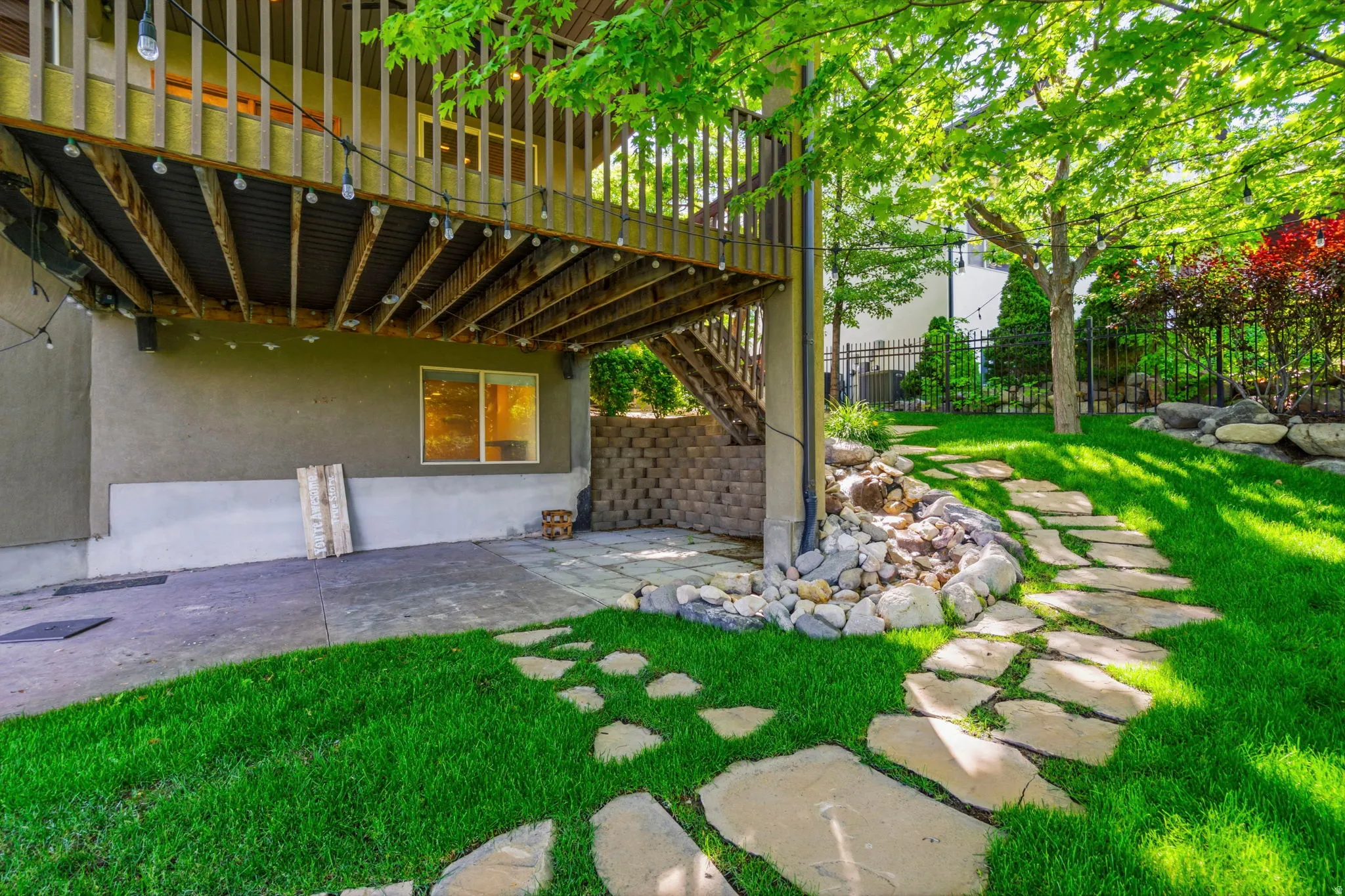 Expansive backyard featuring a manicured lawn and mature trees