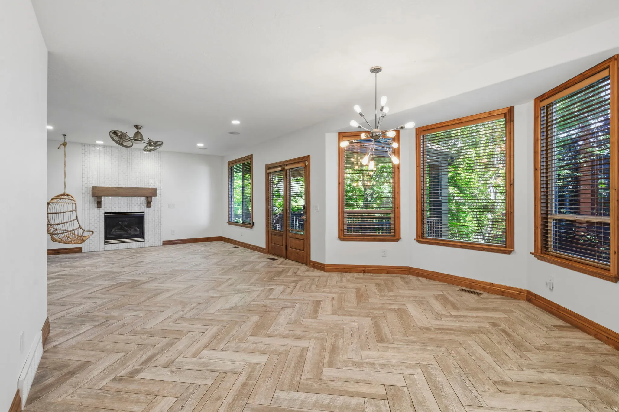 Living room open to the kitchen, with a door to the outside covered deck.