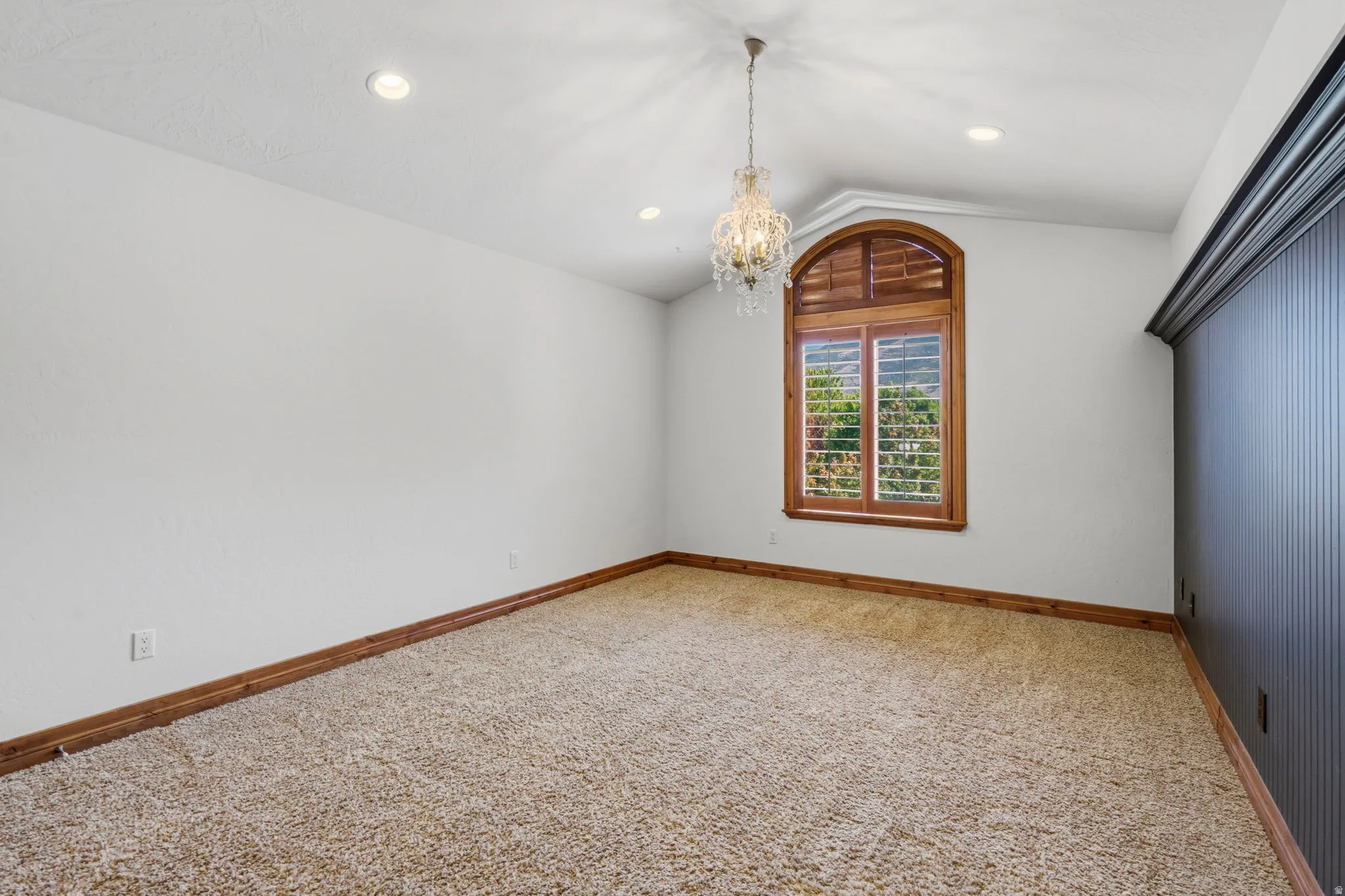 Arched window with wood plantation shutters