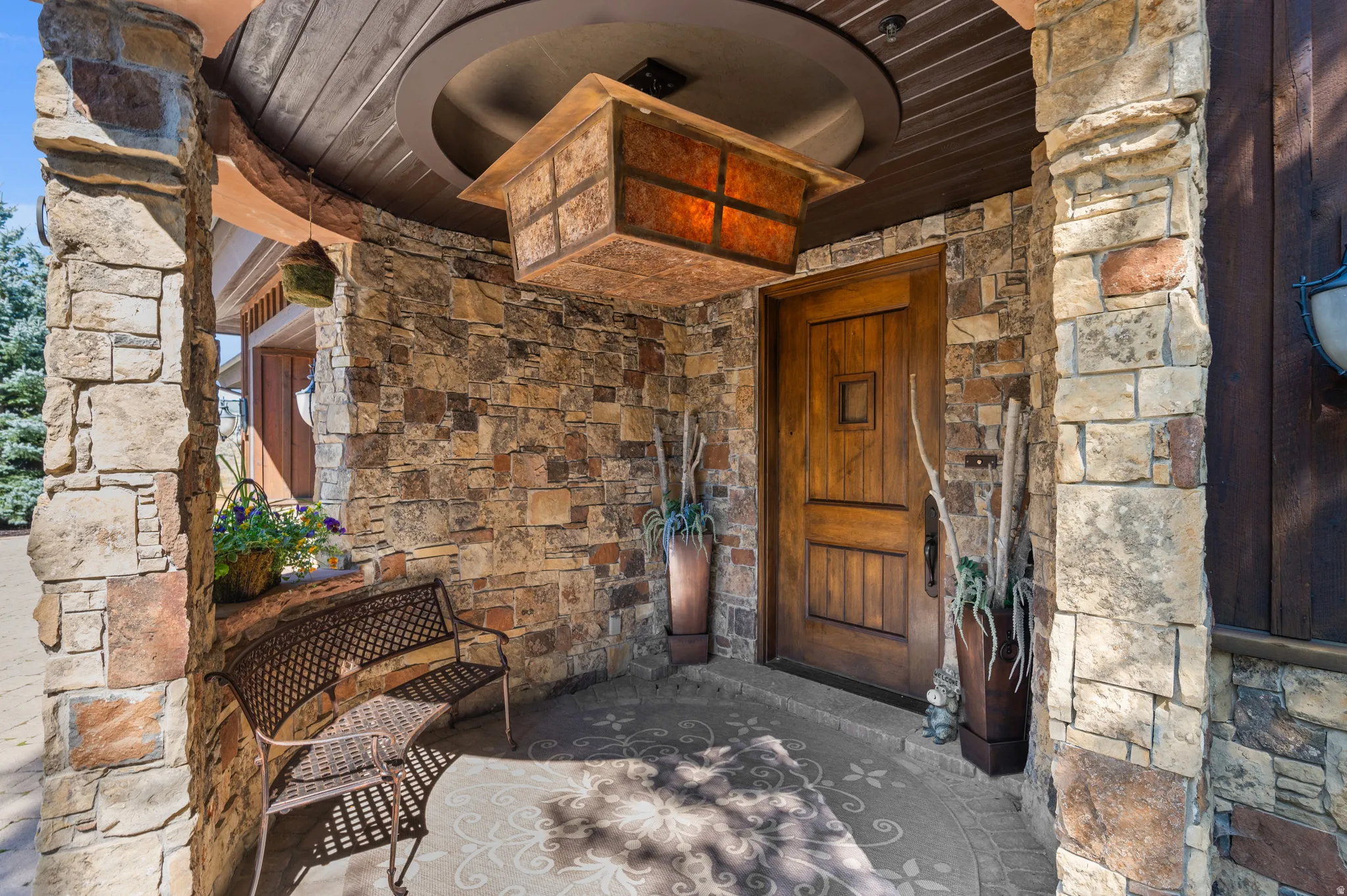 View of exterior entry featuring stone siding