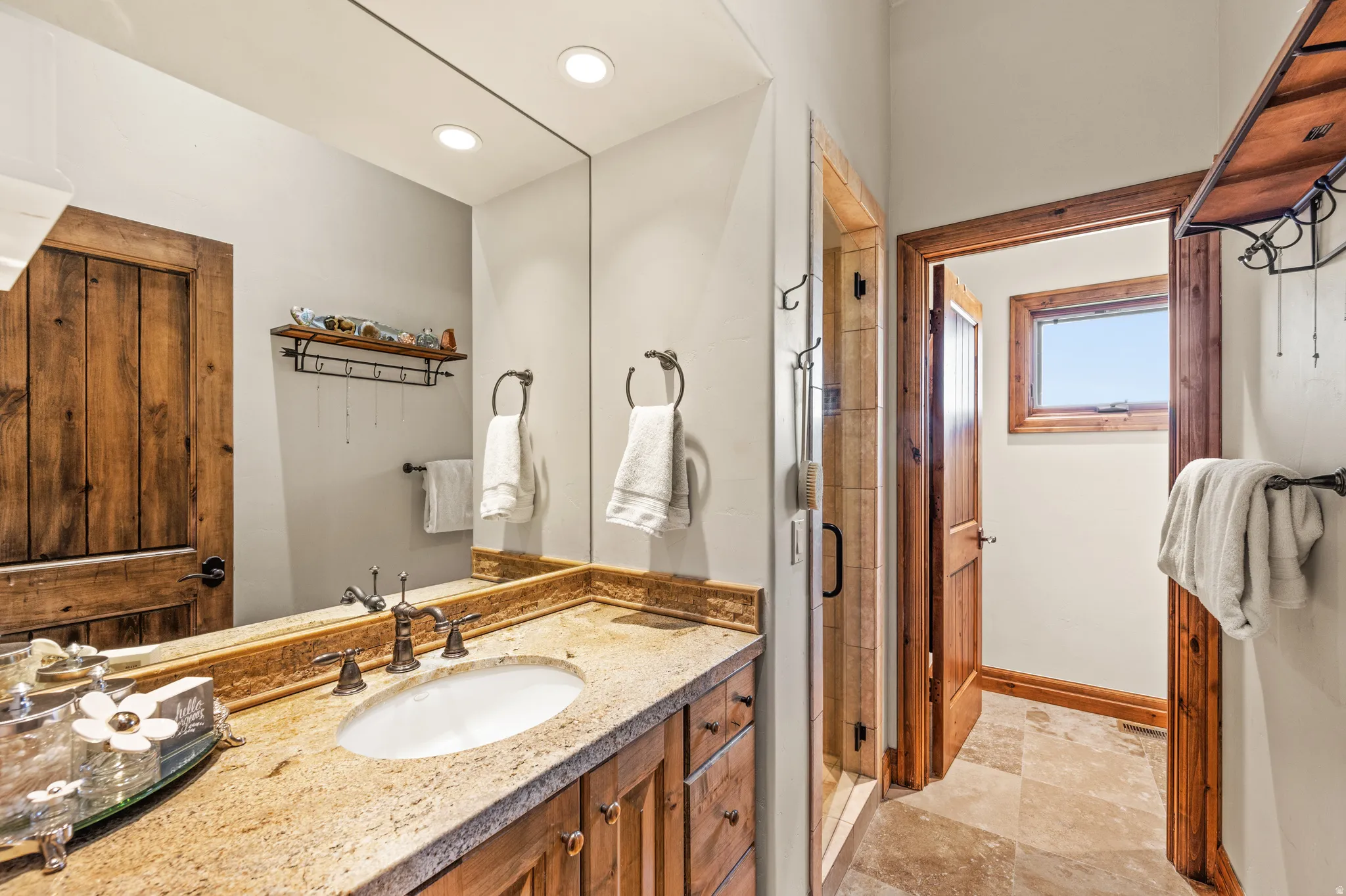 Full bathroom with vanity, a shower stall, light stone finish floors, and recessed lighting