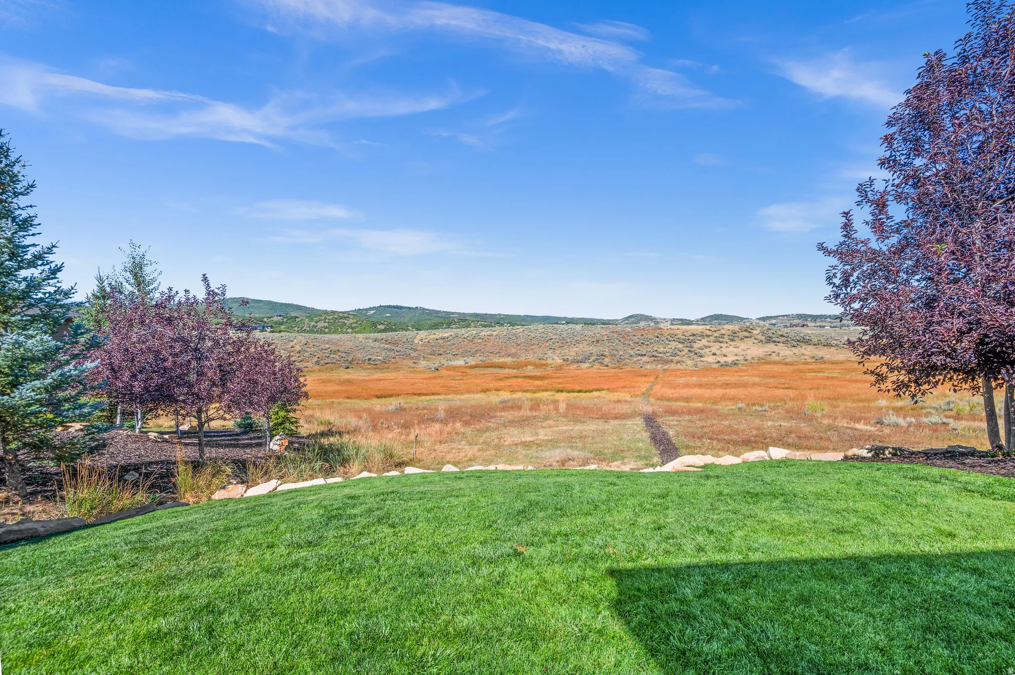 View of green lawn featuring a mountain view