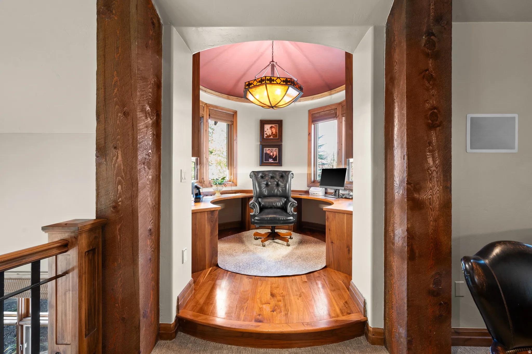 Office featuring wood finished floors and built in study area
