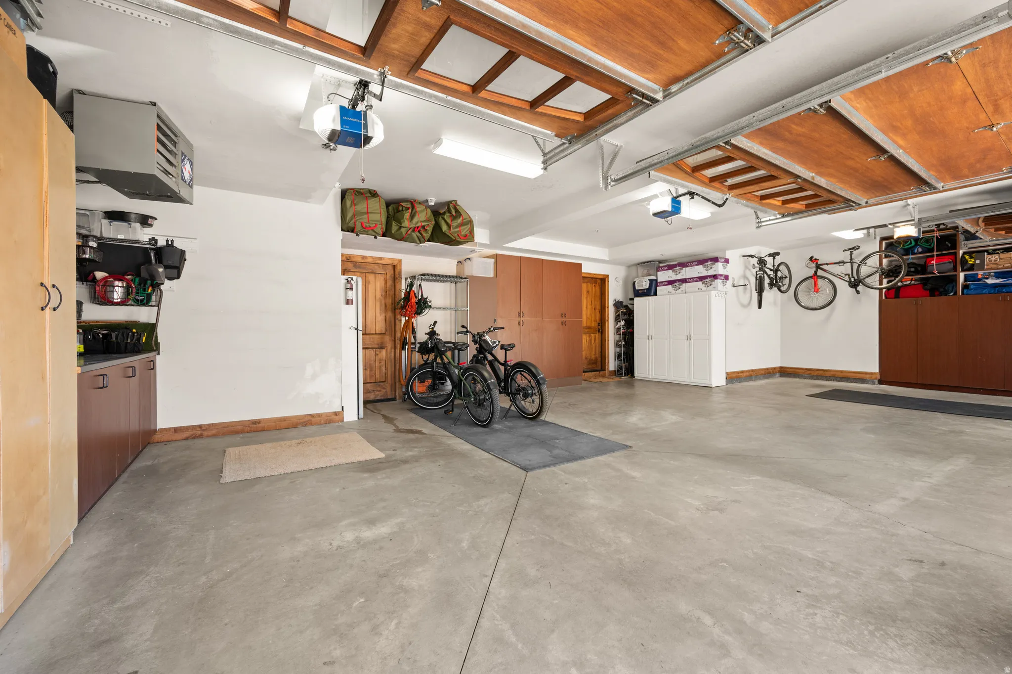 Garage featuring a garage door opener and a heating unit
