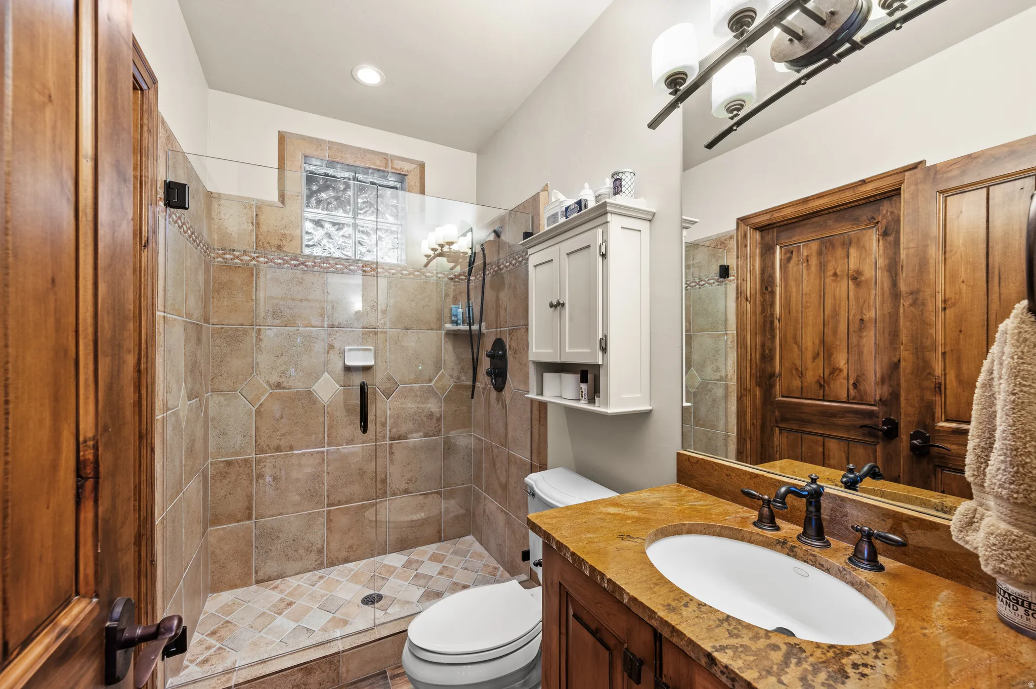 Full bath featuring vanity and a shower stall