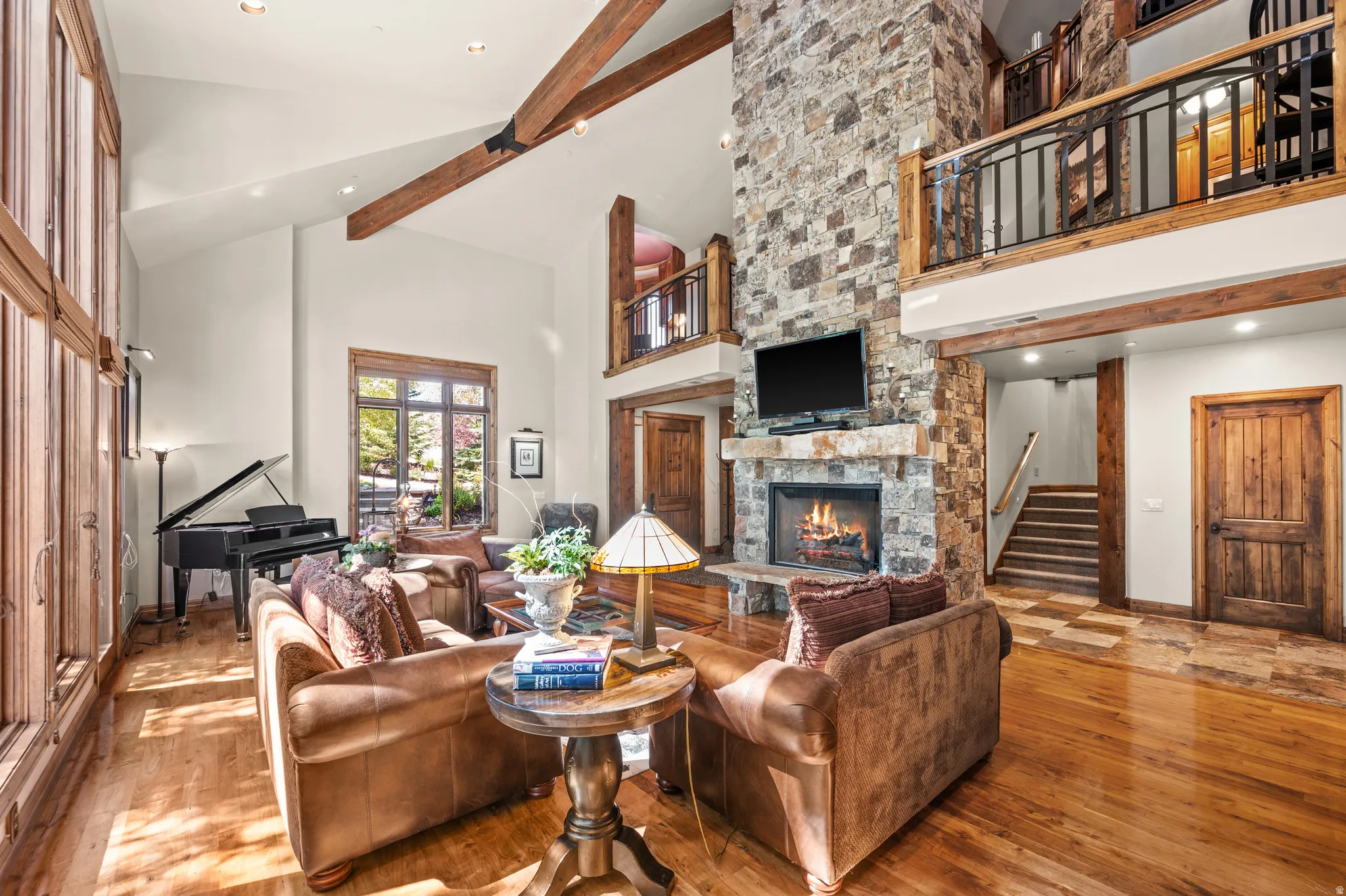 Living room featuring a fireplace, hardwood / wood-style flooring, vaulted ceiling, and recessed lighting