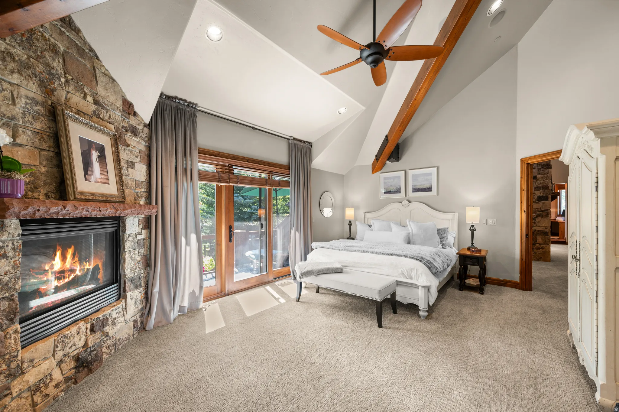 Bedroom featuring access to exterior, light colored carpet, recessed lighting, ceiling fan, and a fireplace
