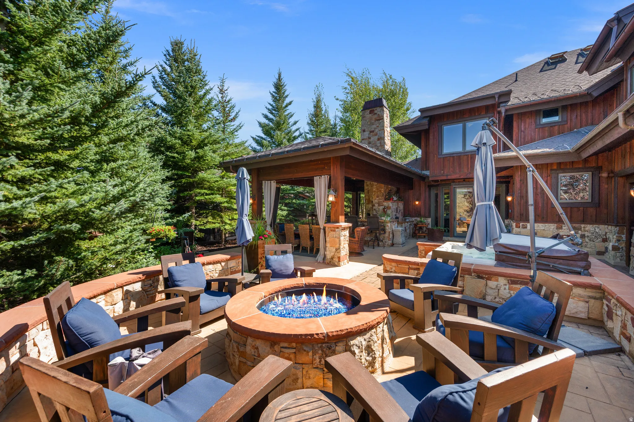 View of patio featuring a fire pit and exterior bar