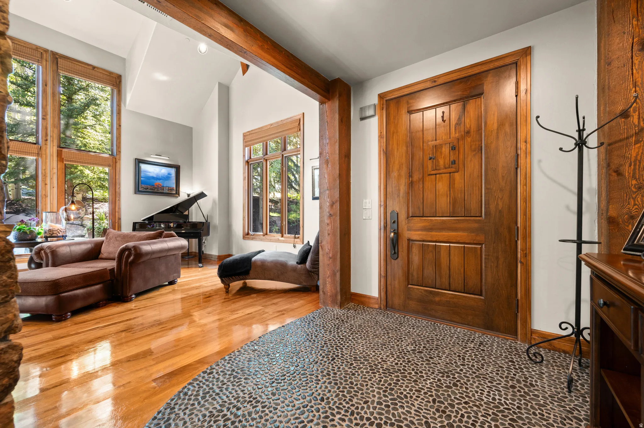 Foyer entrance featuring vaulted ceiling and light wood-type flooring