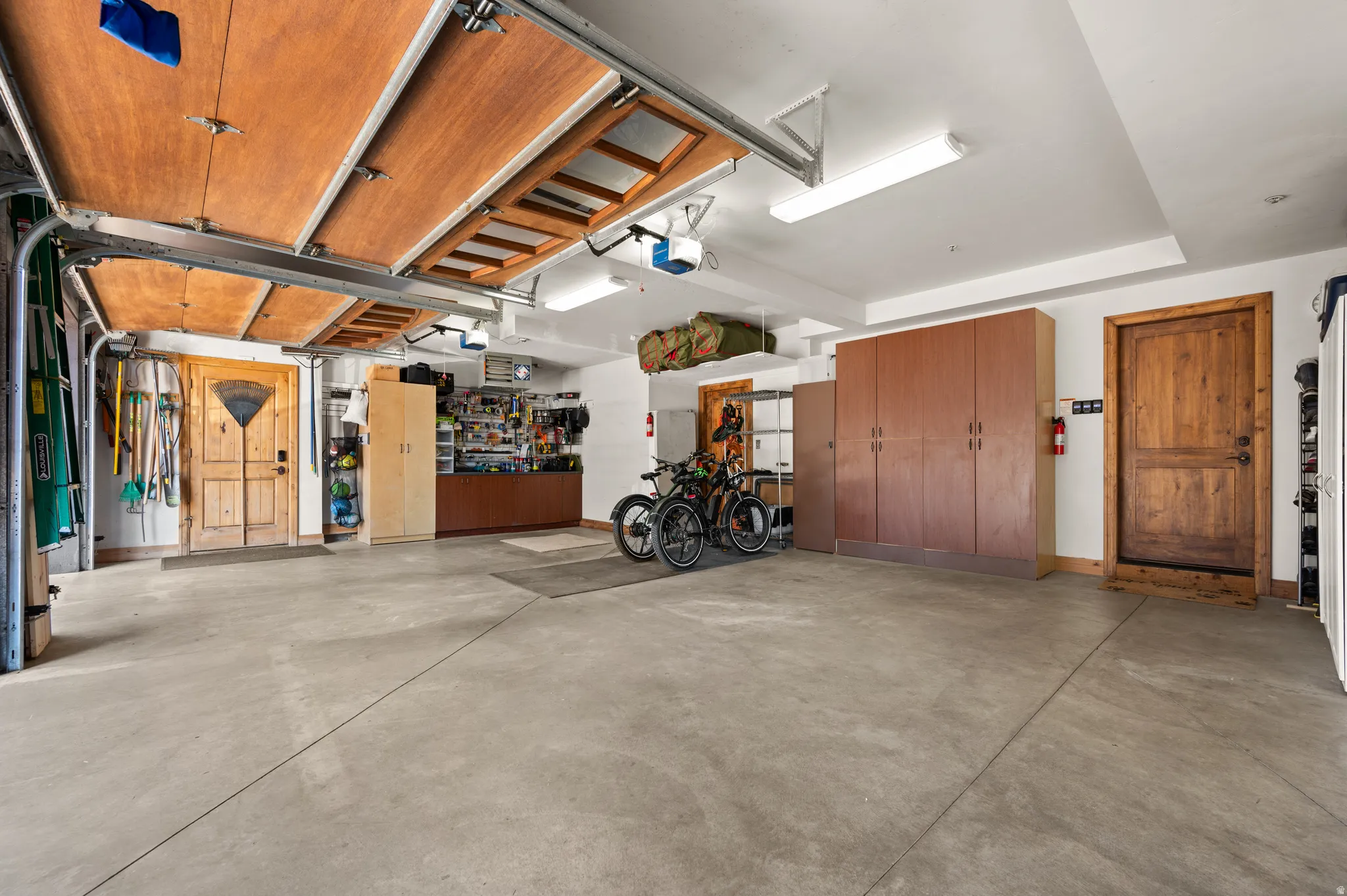 Garage featuring a workshop area and a garage door opener