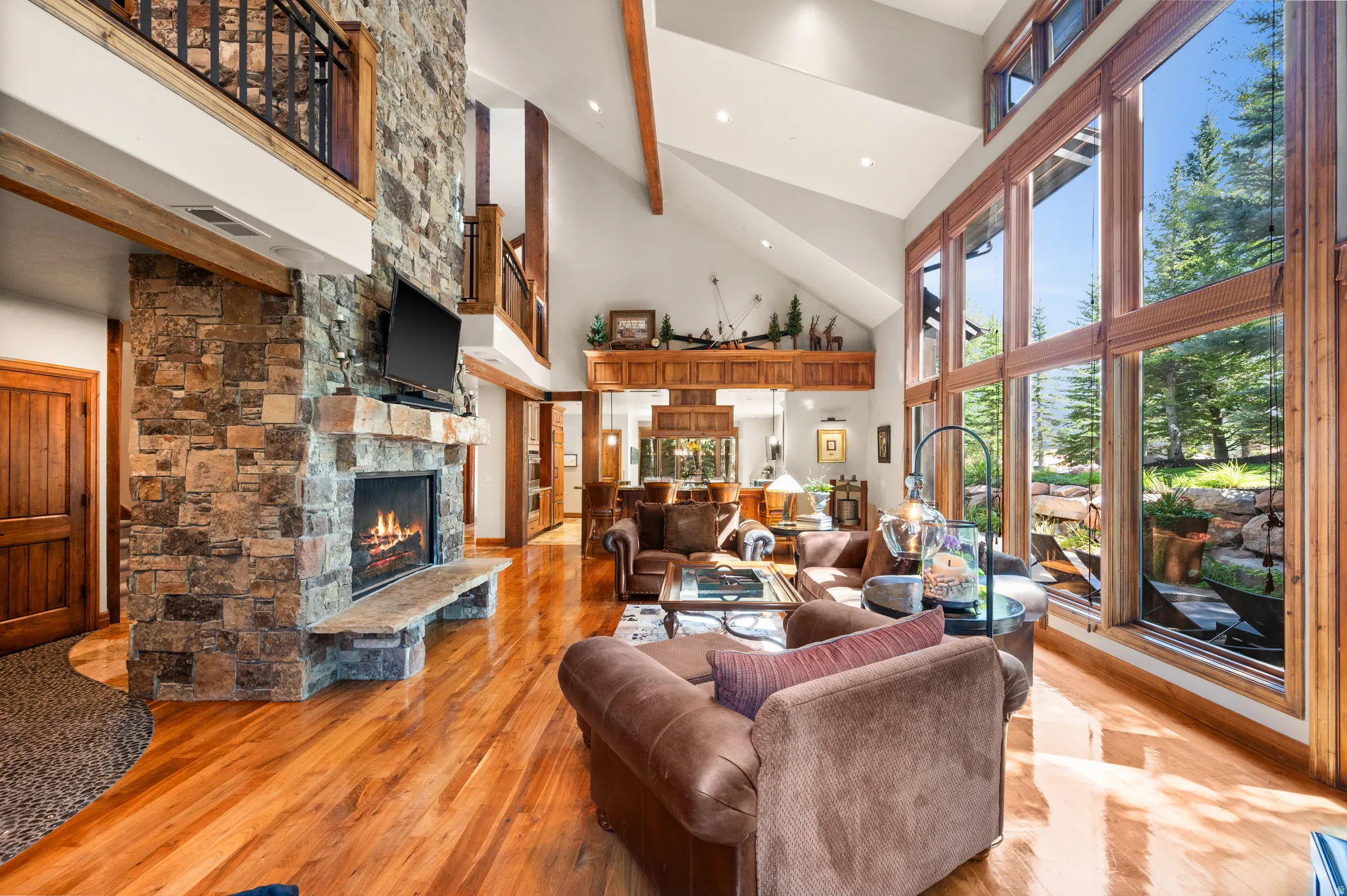 Living area featuring a fireplace, recessed lighting, lofted ceiling, and light wood finished floors