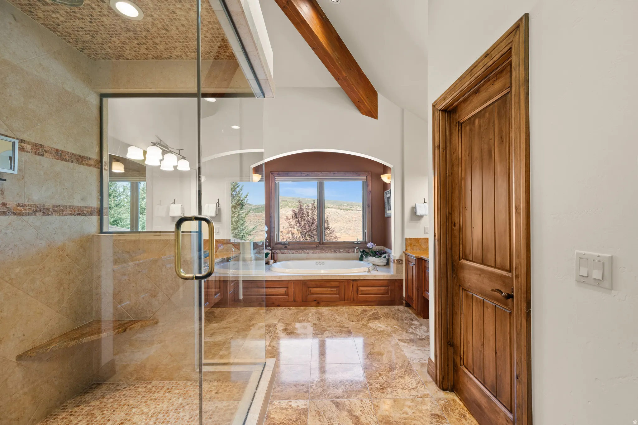 Bathroom with a shower stall, a garden tub, vanity, beamed ceiling, and recessed lighting