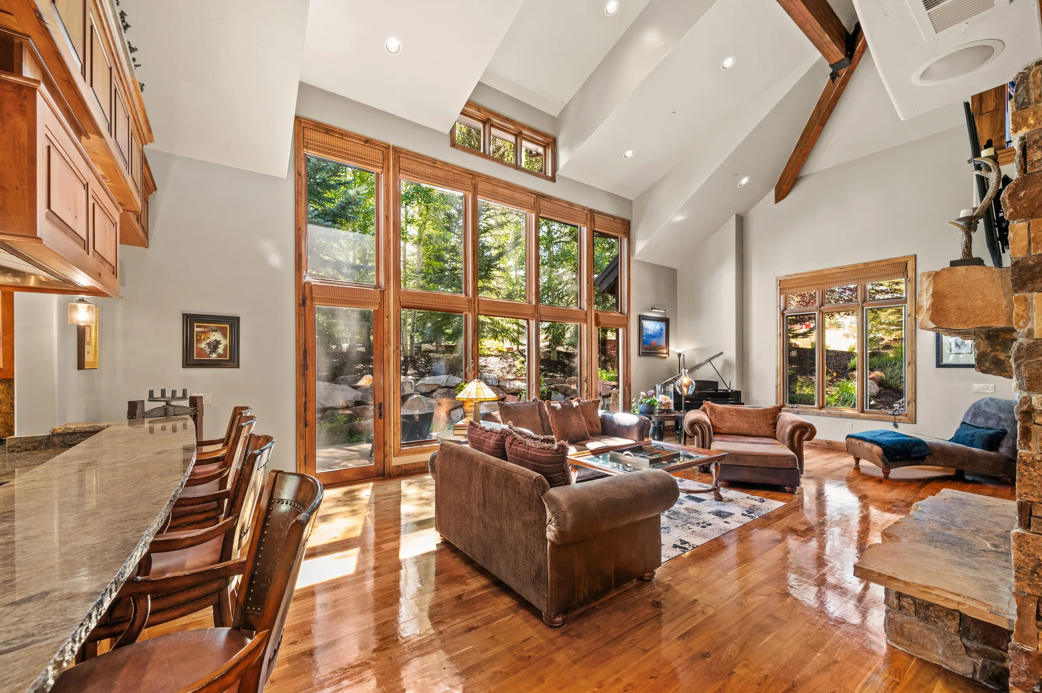 Living room with recessed lighting, hardwood / wood-style floors, and vaulted ceiling