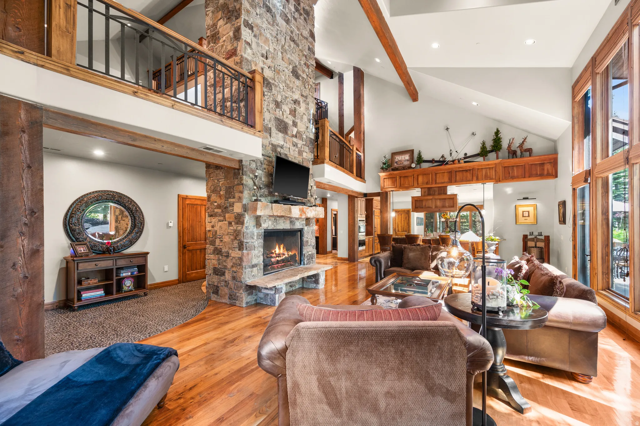 Living area featuring recessed lighting, light wood finished floors, a fireplace, and lofted ceiling