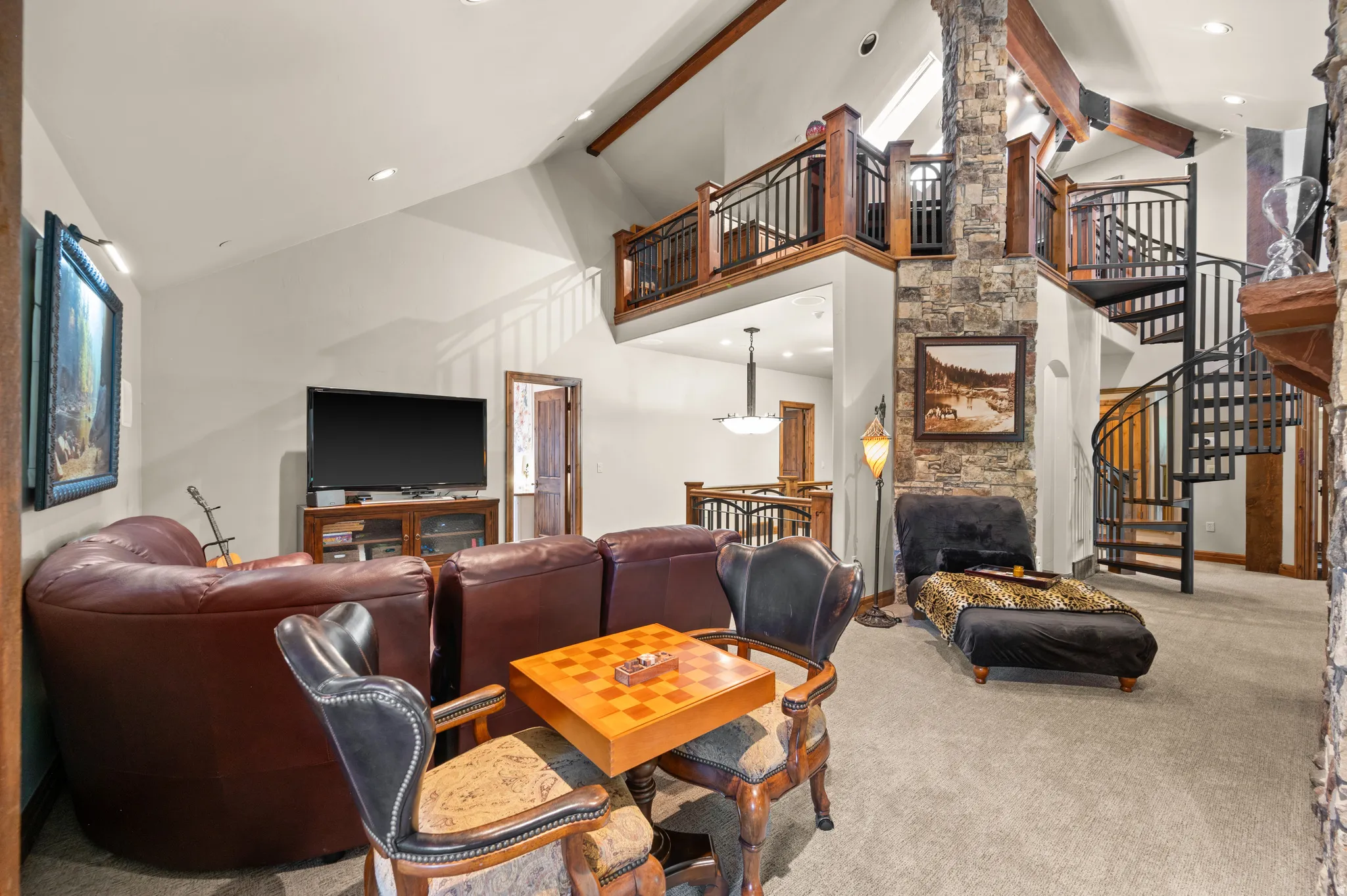 Carpeted living area with lofted ceiling and recessed lighting