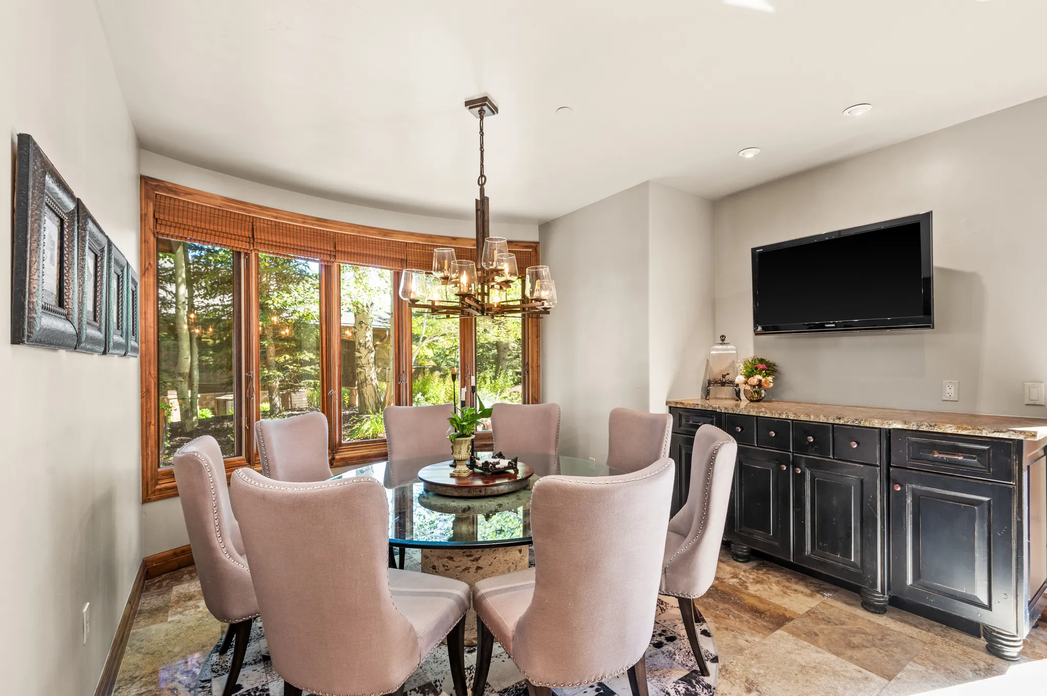 Dining room featuring light stone finish flooring and hanging lights