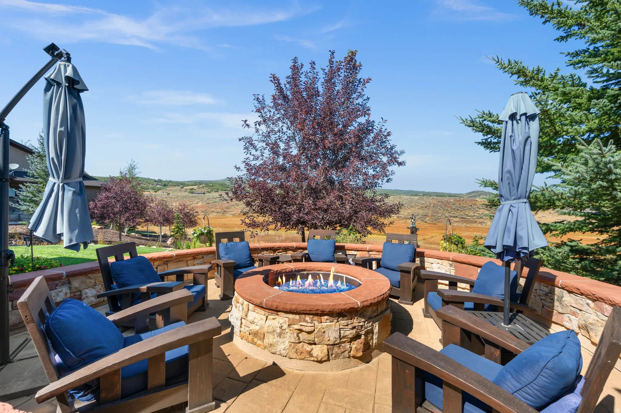 View of patio with an outdoor fire pit