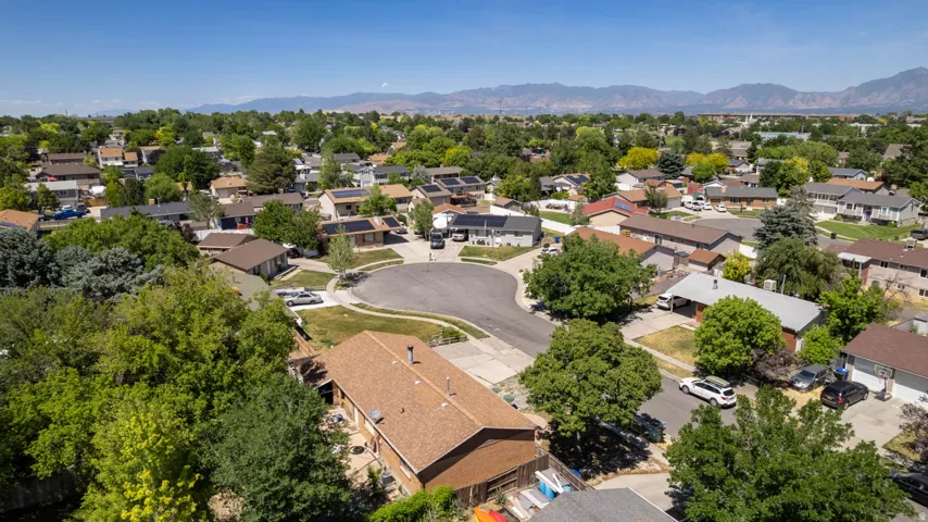 Residential neighborhood with mature trees, established properties, and cul-de-sac street layout