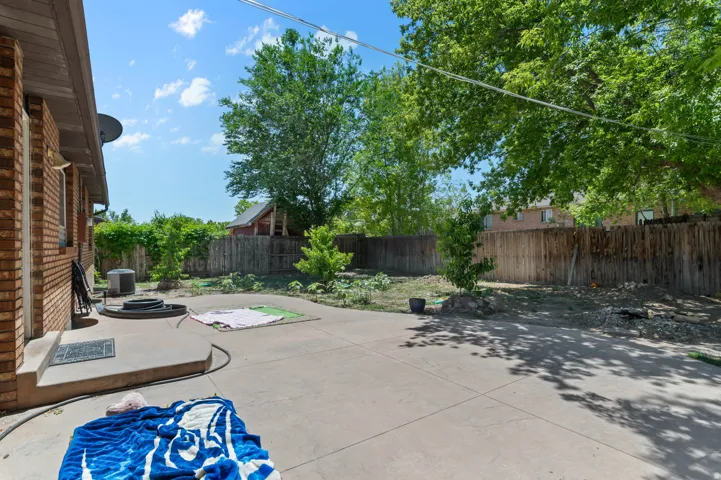 Expansive concrete patio area with brick exterior detailing