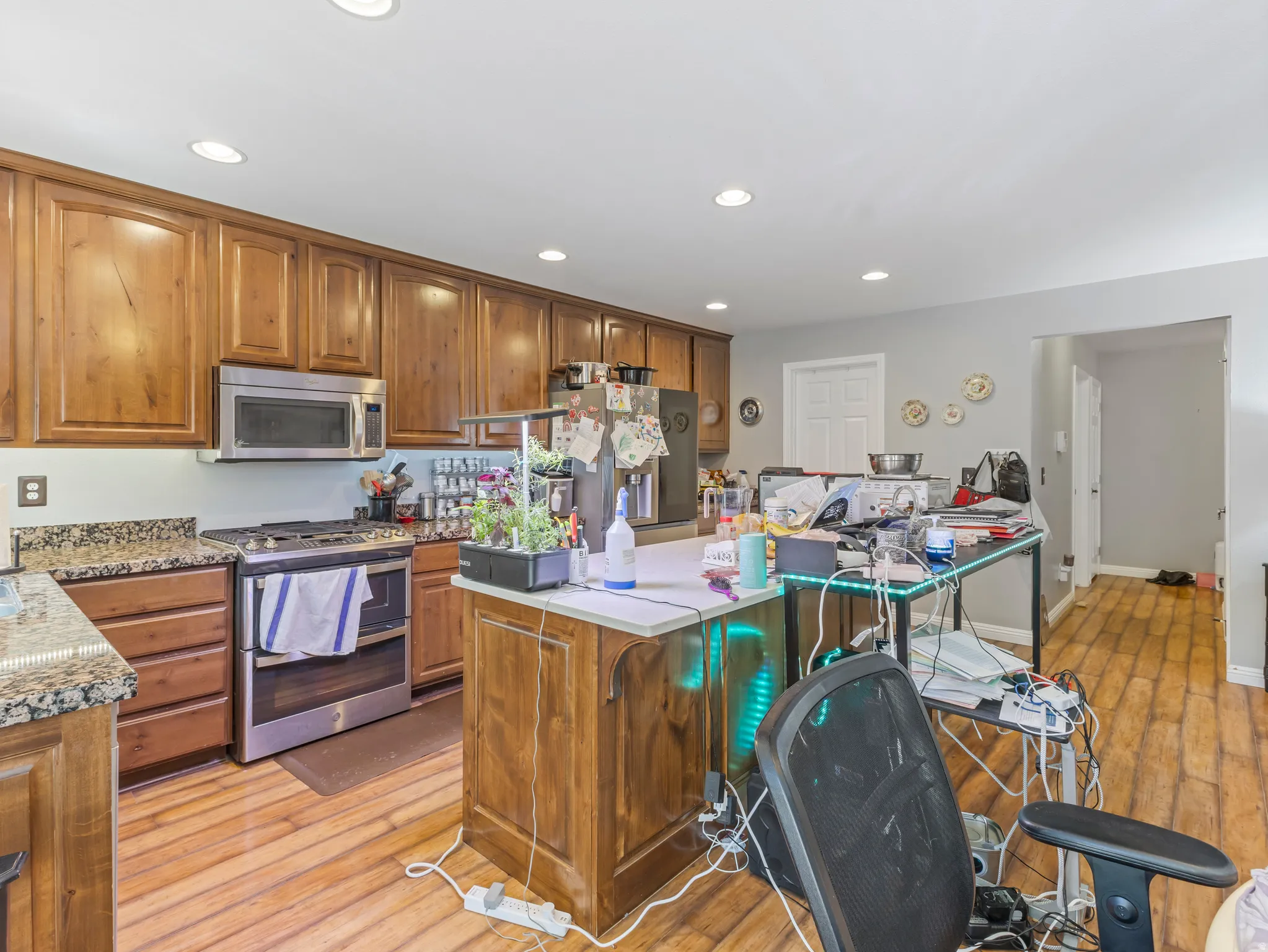 Kitchen featuring wood-finish flooring, recessed lighting, and full-height wood cabinetry