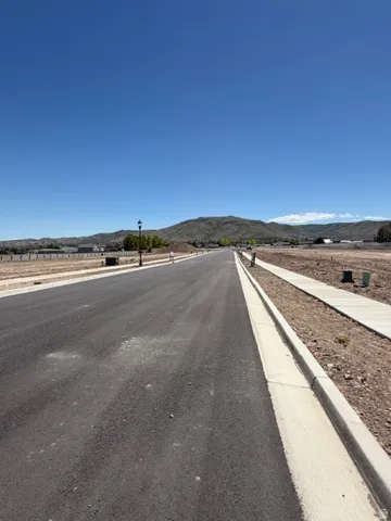 Paved street frontage with integrated sidewalks and curb infrastructure