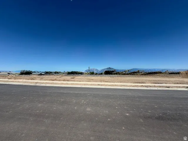 Expansive land parcel featuring clear skies and distant mountain ranges