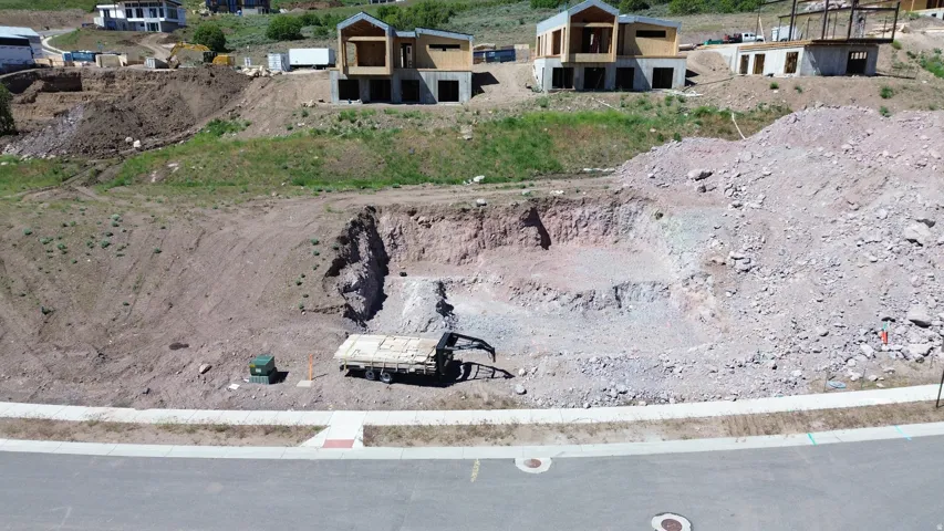Graded lot featuring a leveled building pad and excavated foundation area