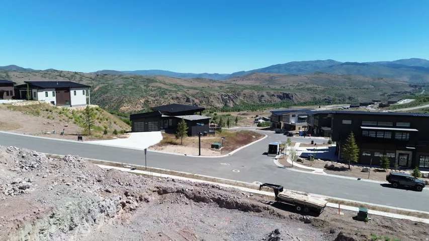 Modern residential development featuring contemporary architecture and mountainous terrain
