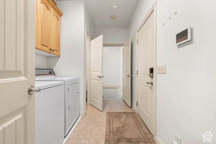 Main floor hallway off the kitchen with laundry area. Doorways to the garage (on the right), basement (straight ahead) and bathroom (open door on the left).