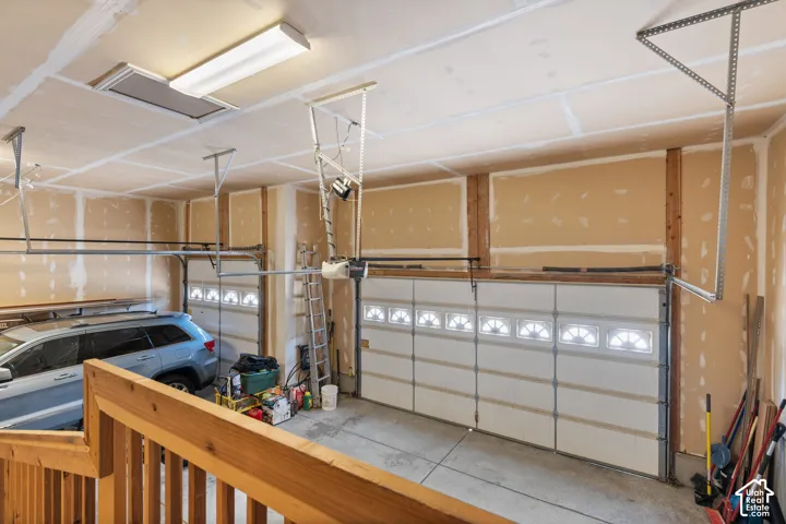 Spacious three-car garage featuring automatic overhead doors