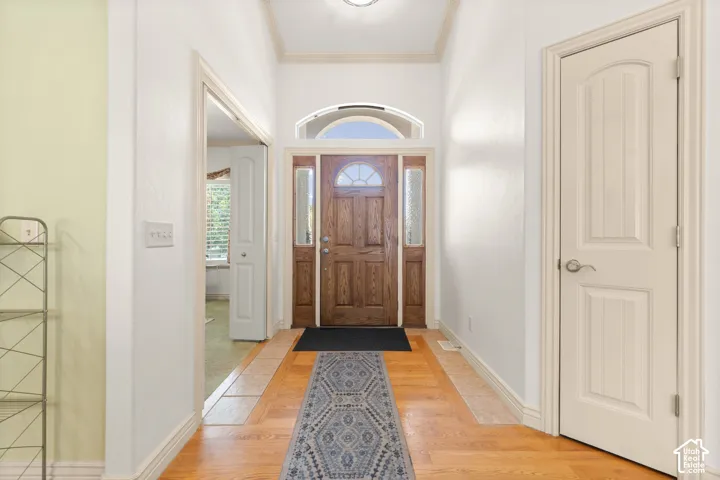 Entryway featuring a wood-finish door with sidelight windows and an arched transom