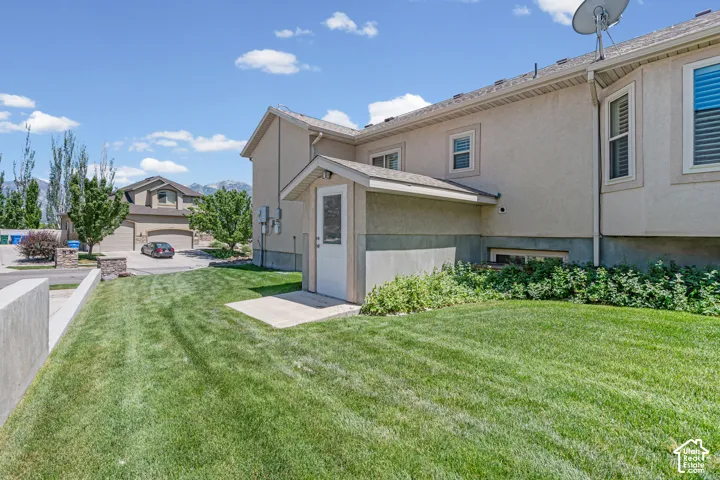Expansive lawn area with a stucco-clad exterior