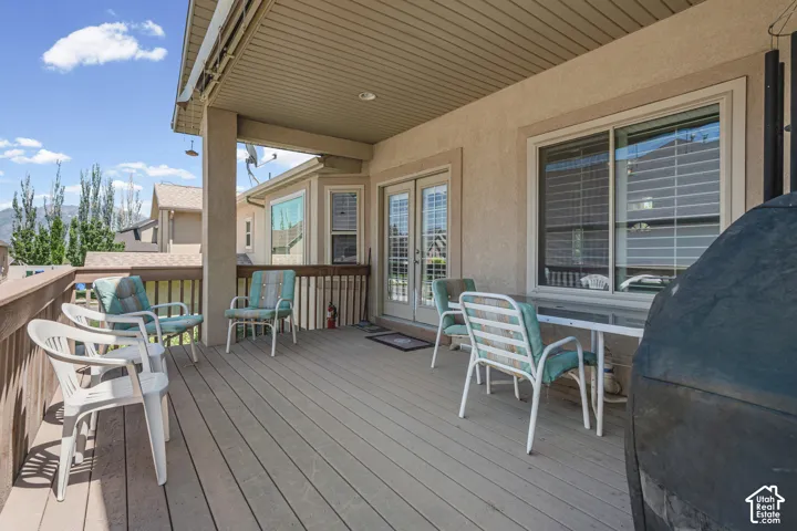 Expansive covered deck featuring composite decking. Direct access to interior spaces via double glass doors